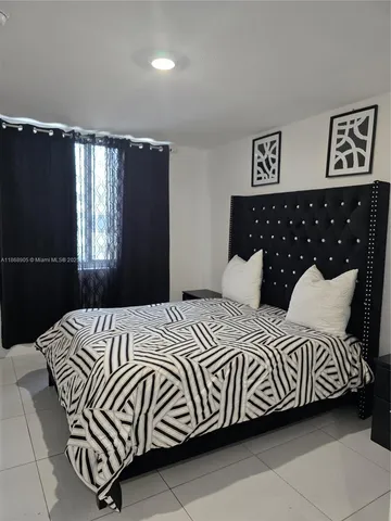 a bedroom with a bed and window