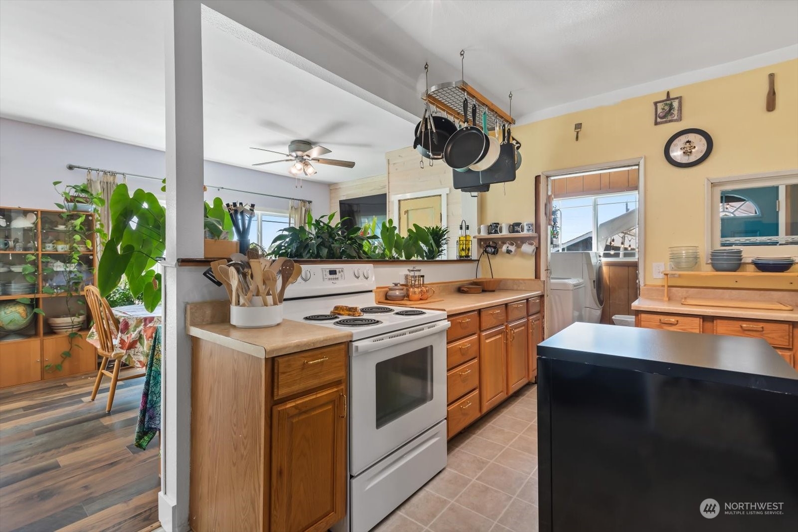 1306 38th Street Everett, WA 98201 - Photo 2 of 37 a kitchen with stainless steel appliances granite countertop a stove and a large window with wooden floor