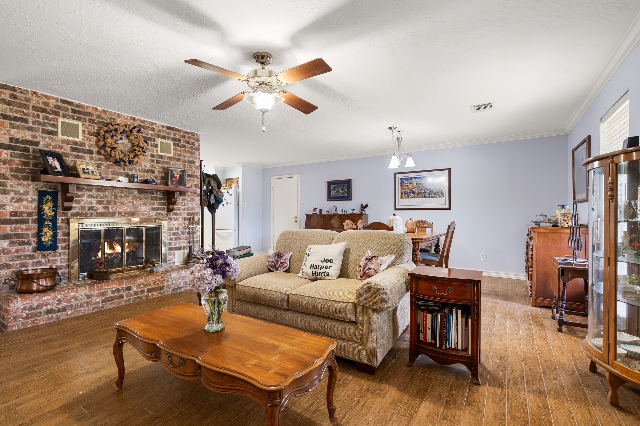 12156 Crockett Martin Road Conroe, TX 77306 - Photo 14 of 45 a living room with furniture a fireplace and a flat screen tv