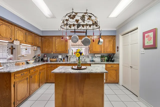 a kitchen with stainless steel appliances granite countertop a sink and a refrigerator