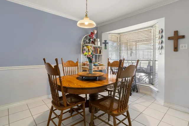 a dining room with furniture and window
