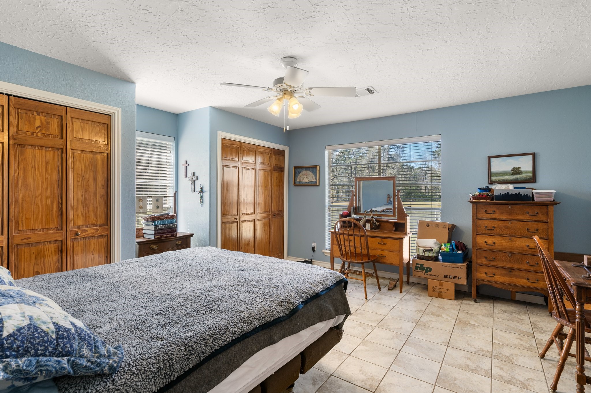 12156 Crockett Martin Road Conroe, TX 77306 - Photo 25 of 45 a bedroom with a bed and a chandelier