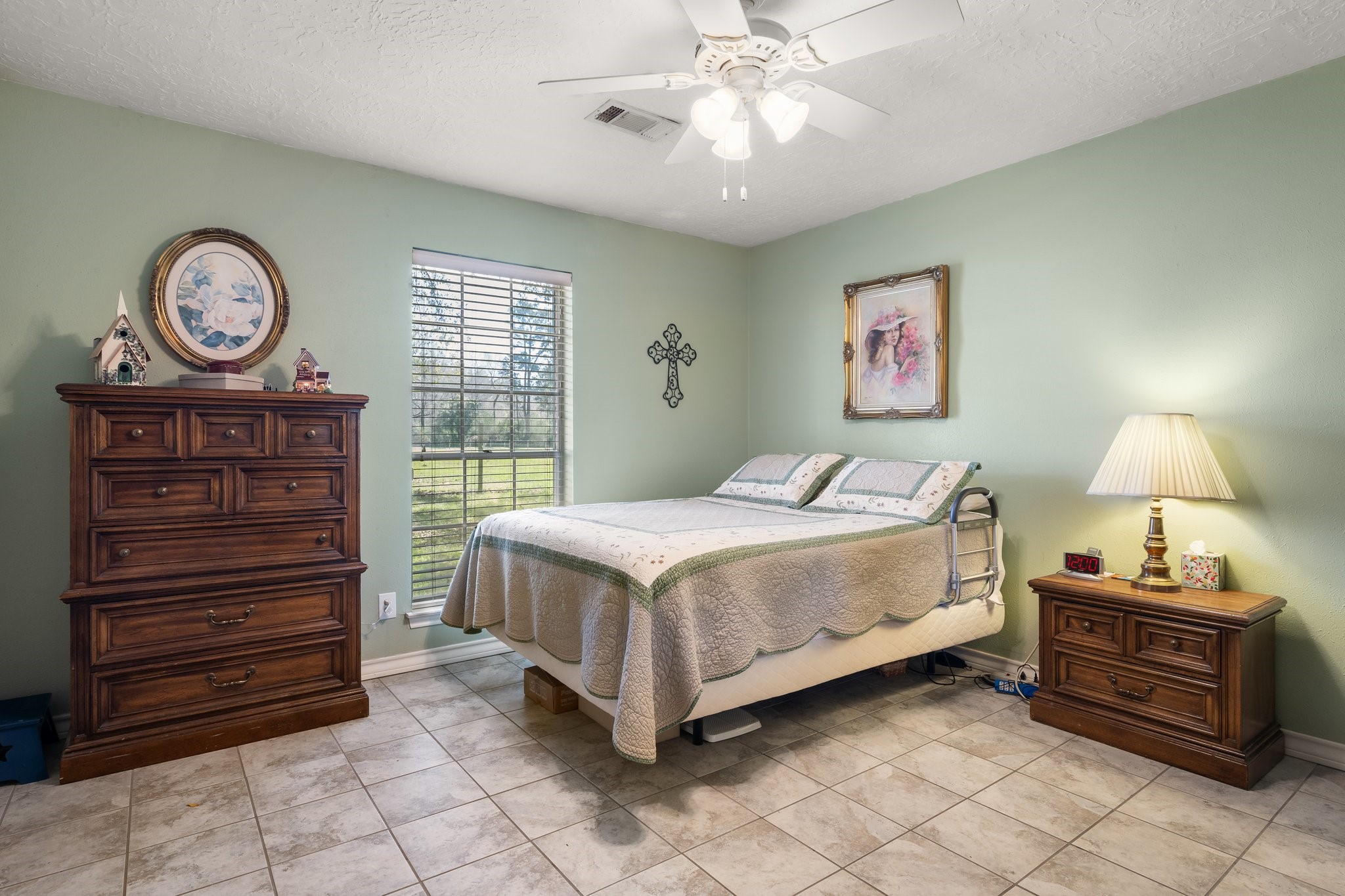 12156 Crockett Martin Road Conroe, TX 77306 - Photo 30 of 45 a bedroom with a bed and a chandelier