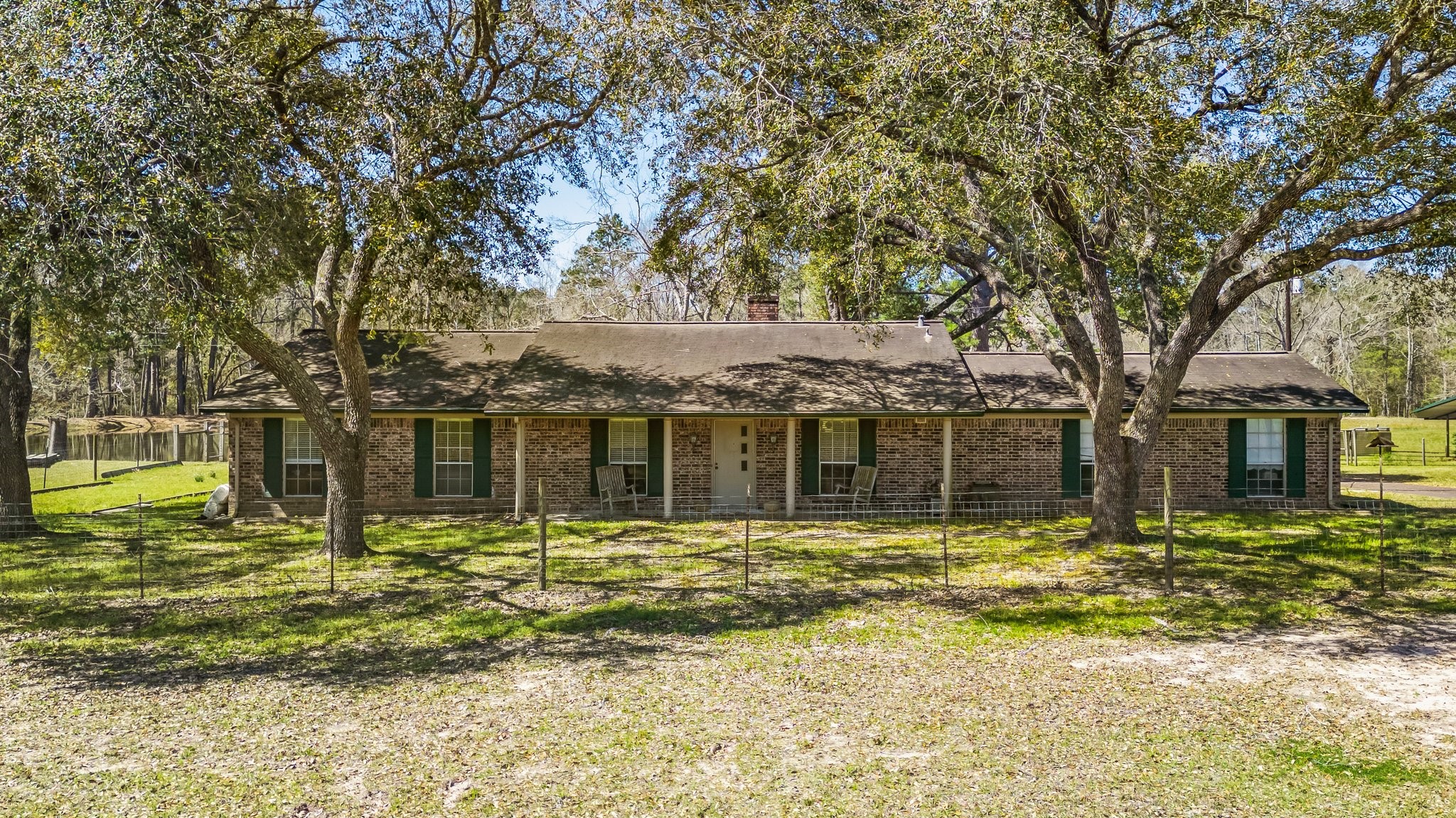 12156 Crockett Martin Road Conroe, TX 77306 - Photo 3 of 45 a front view of a house with a garden
