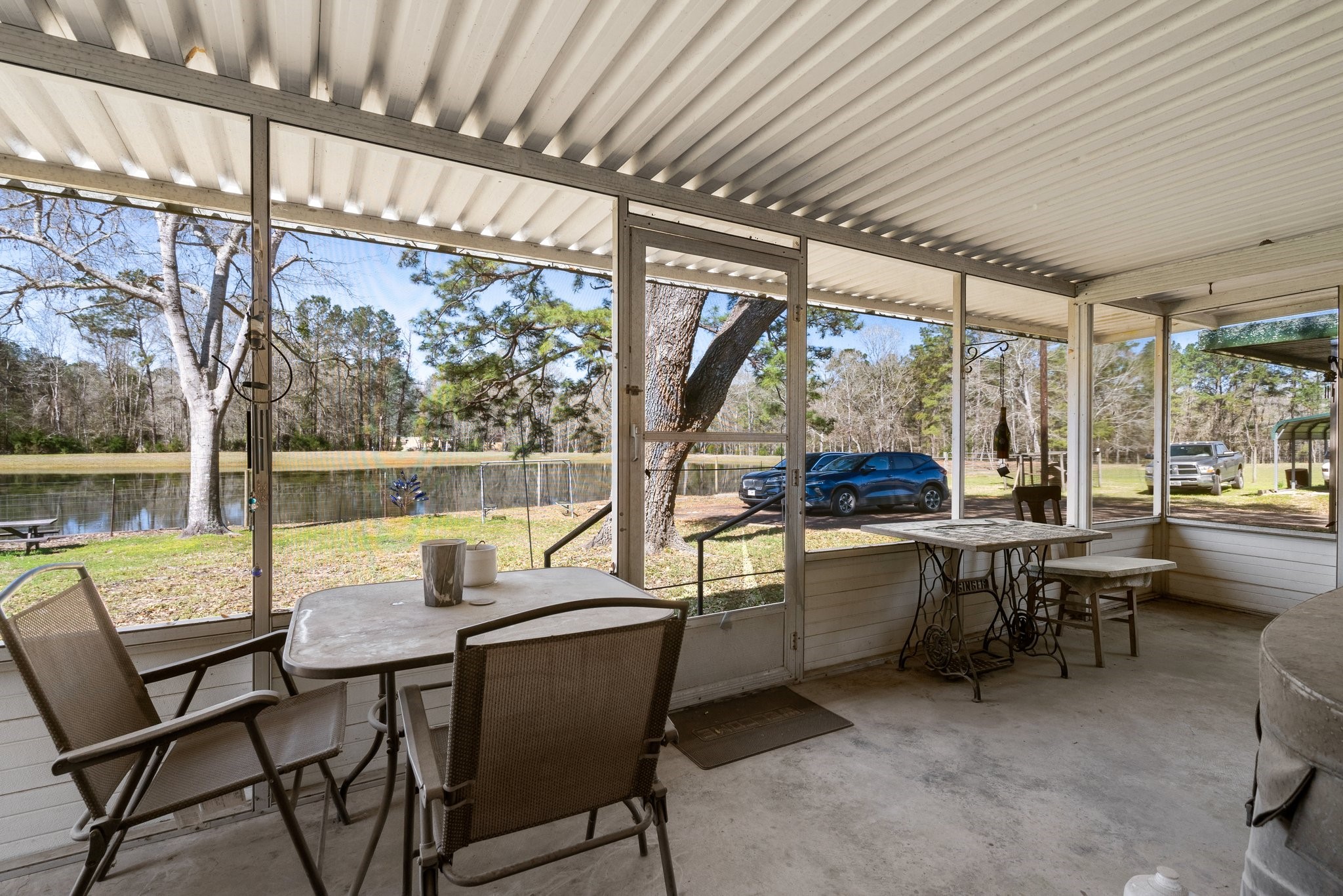 12156 Crockett Martin Road Conroe, TX 77306 - Photo 32 of 45 a view of a large swimming pool with a table and chairs