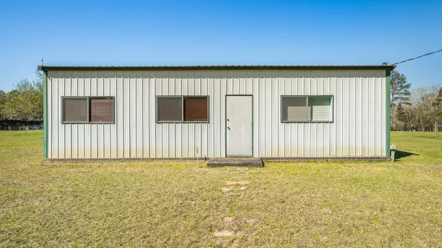 a view of a house with a yard and garage