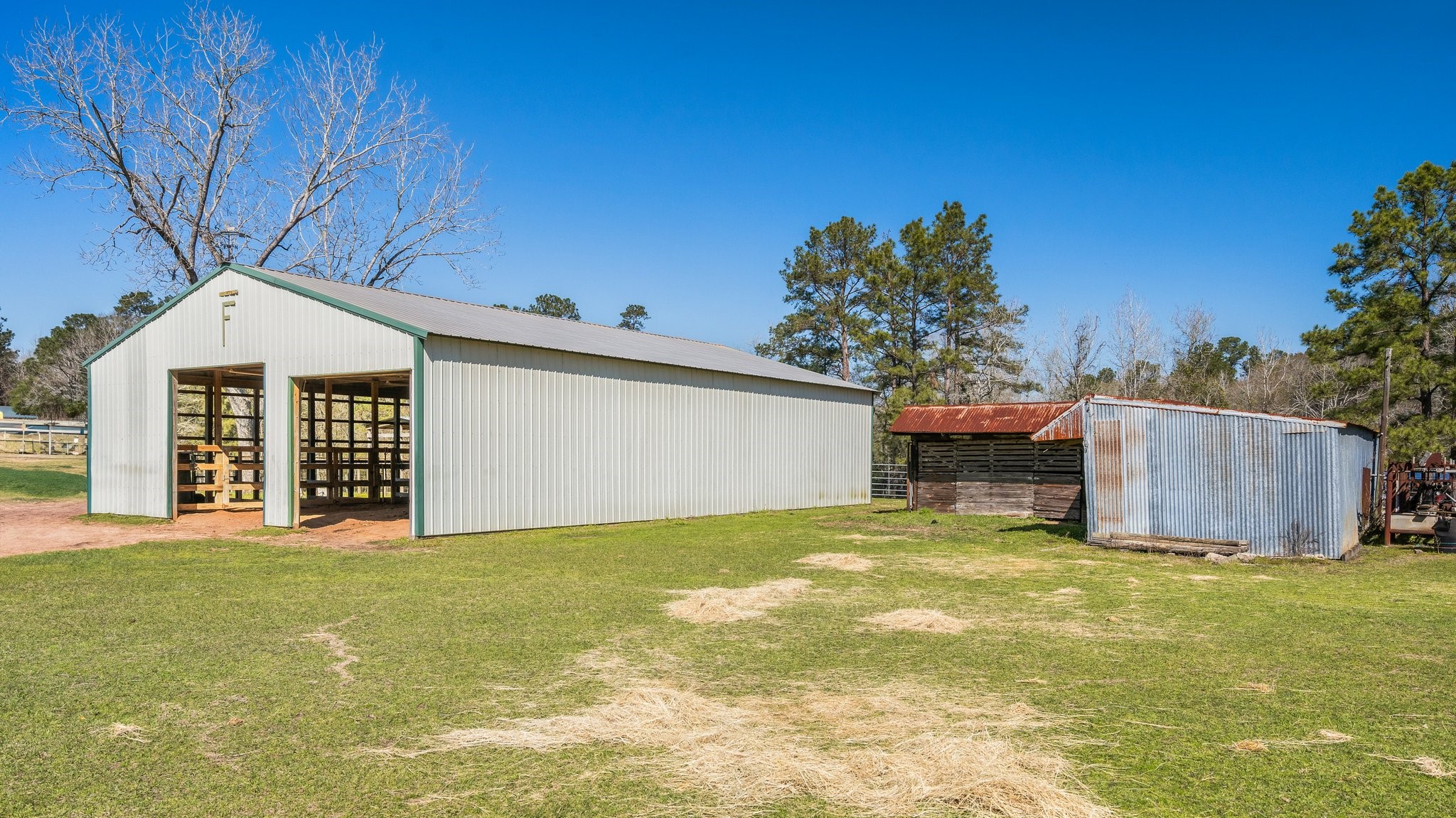 12156 Crockett Martin Road Conroe, TX 77306 - Photo 42 of 45 a view of a house with a yard and garage