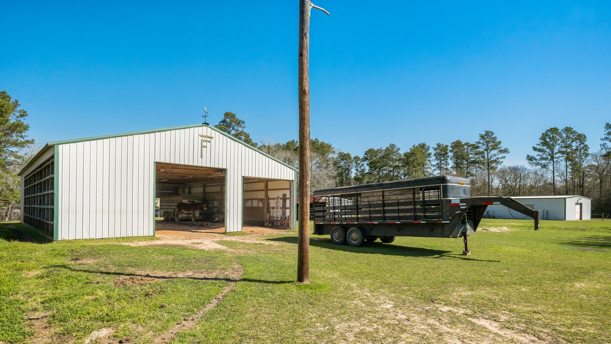 12156 Crockett Martin Road Conroe, TX 77306 - Photo 43 of 45 a view of a house with a backyard porch and sitting area
