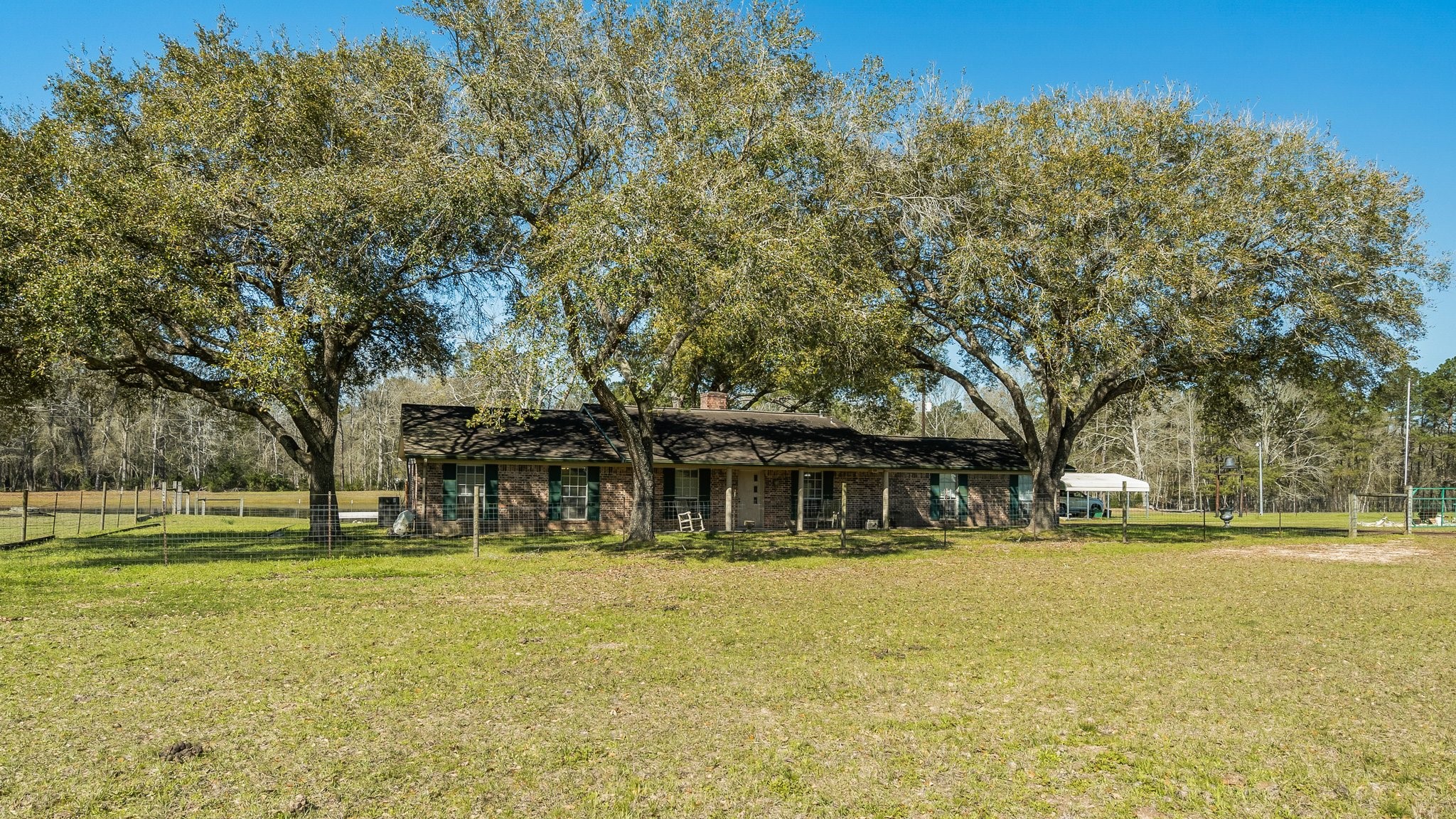12156 Crockett Martin Road Conroe, TX 77306 - Photo 8 of 45 a front view of a building with a yard