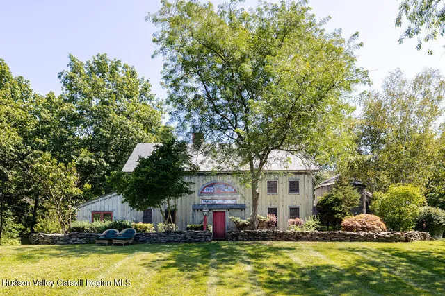 a front view of house with yard space and swimming pool