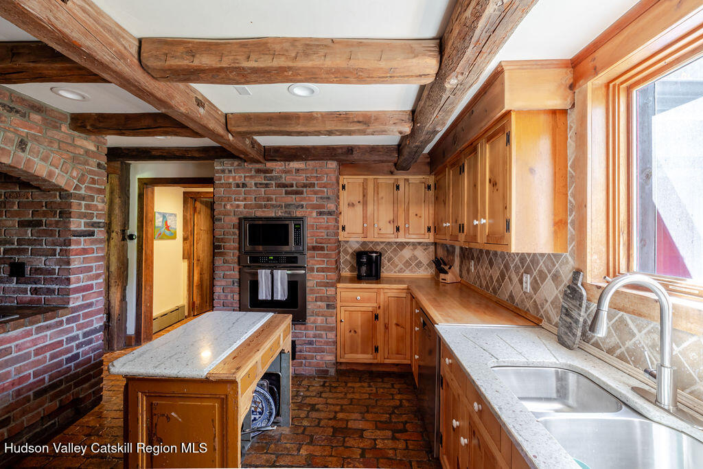 455 Post Hill Road Craryville, NY 12521 - Photo 13 of 53 a view of a kitchen with furniture and a fireplace