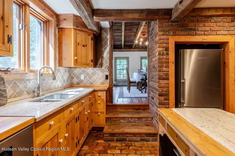 a spacious bathroom with a granite countertop sink and a large mirror