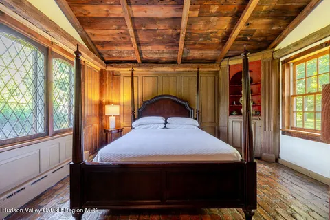 a bedroom with a bed a table and chair