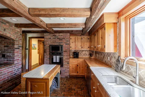 a spacious bathroom with a double vanity sink a mirror and bathtub