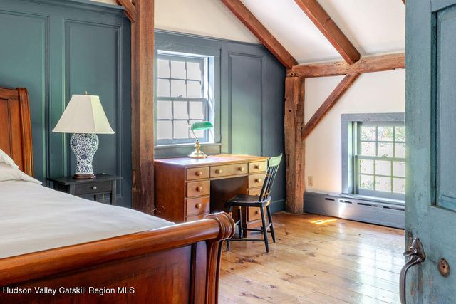 a reading room with furniture and a large window