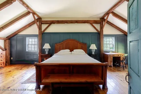 a bedroom with a bed and a large window