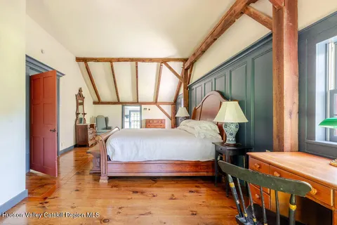 a bedroom with a bed and a large window