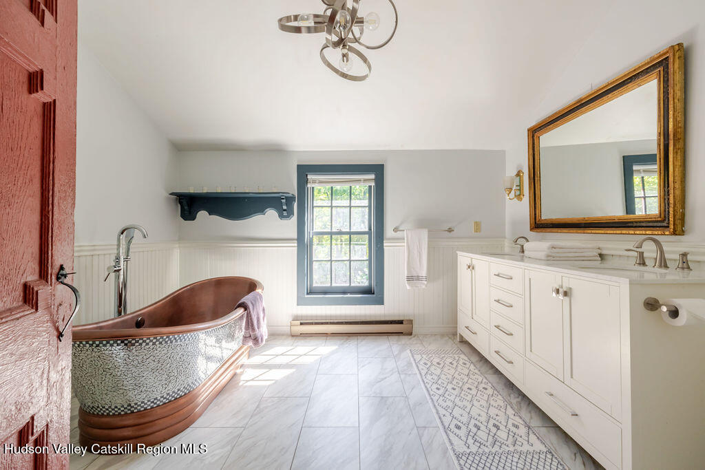455 Post Hill Road Craryville, NY 12521 - Photo 24 of 53 a spacious bathroom with a double vanity sink a mirror and bathtub