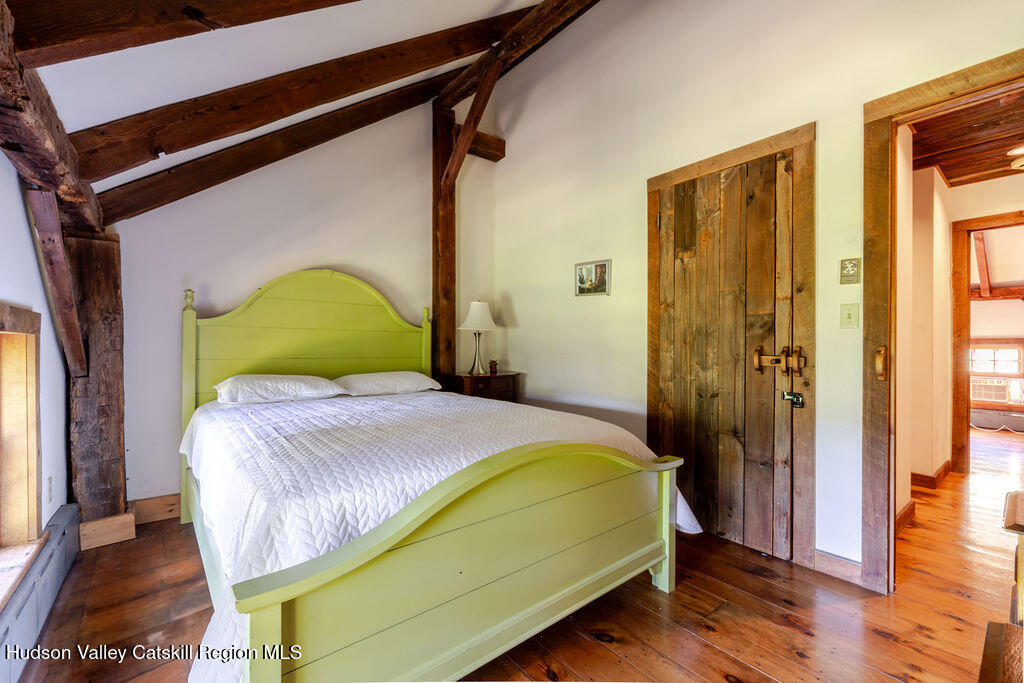 455 Post Hill Road Craryville, NY 12521 - Photo 29 of 53 a bedroom with a bed and wooden floor