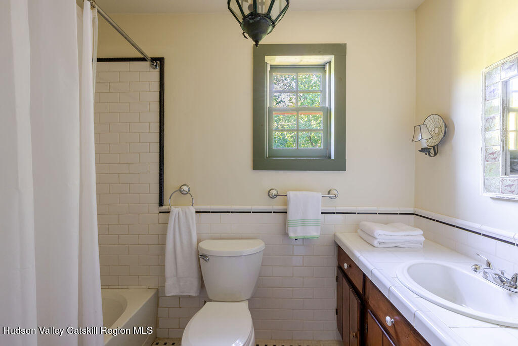 455 Post Hill Road Craryville, NY 12521 - Photo 30 of 53 a bathroom with a toilet sink and mirror