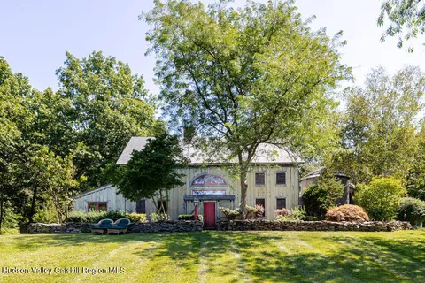 a front view of house with yard space and swimming pool