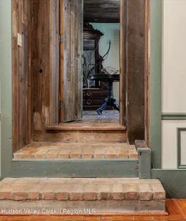 a view of a a dining room with furniture window and wooden floor