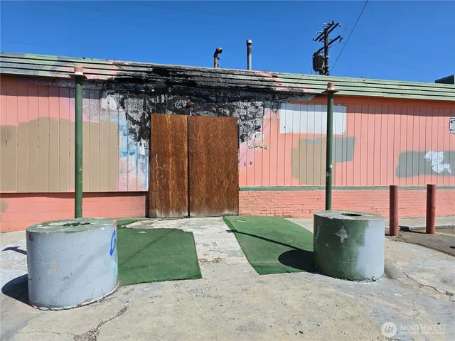 a white house with a small yard and wooden fence