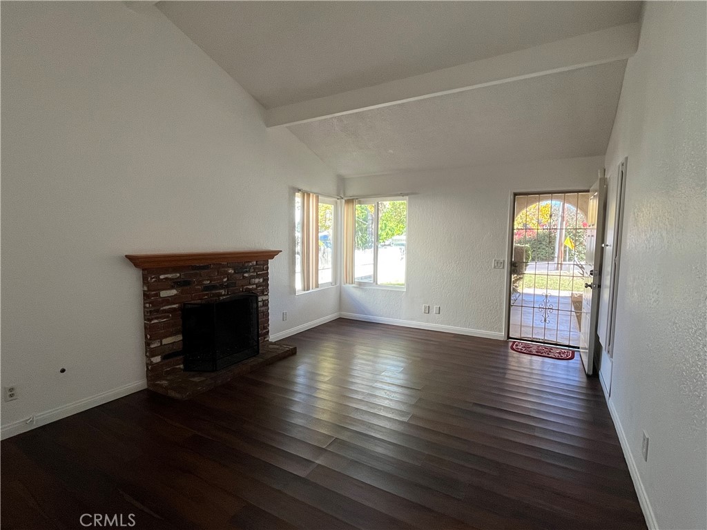 3842 Ridge Road Riverside, CA 92501 - Photo 5 of 26 an empty room with wooden floor fireplace and windows