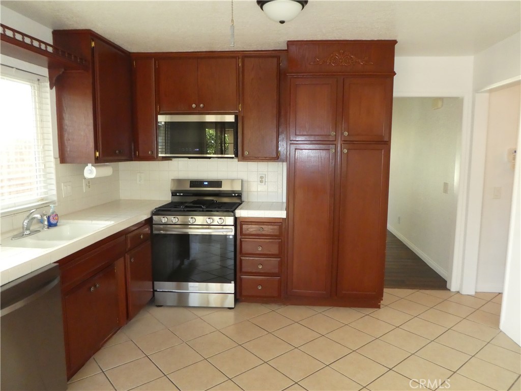 3842 Ridge Road Riverside, CA 92501 - Photo 7 of 26 a kitchen with a refrigerator and a sink