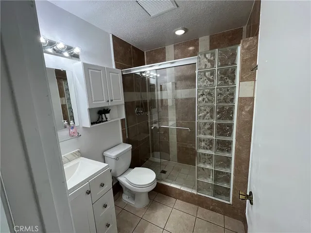 a bathroom with a shower a toilet and a sink
