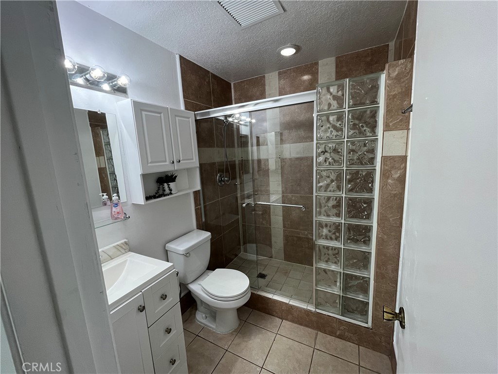 3842 Ridge Road Riverside, CA 92501 - Photo 10 of 26 a bathroom with a shower a toilet and a sink
