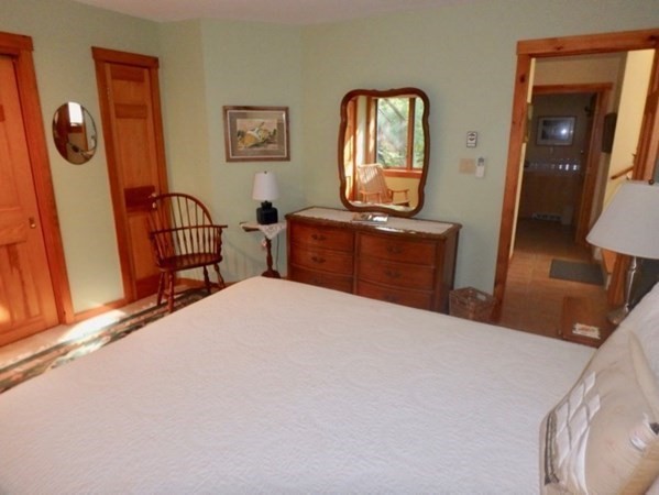 29 Cemetery Road Chilmark, MA 02535 - Photo 14 of 32 a bedroom with a bed and wooden floor
