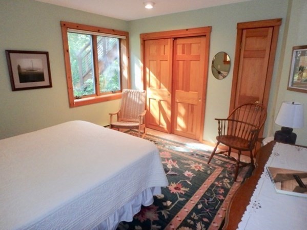 29 Cemetery Road Chilmark, MA 02535 - Photo 15 of 32 a bedroom with a bed and wooden floor