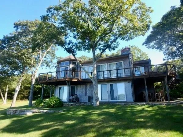 a view of a house with a yard and sitting area