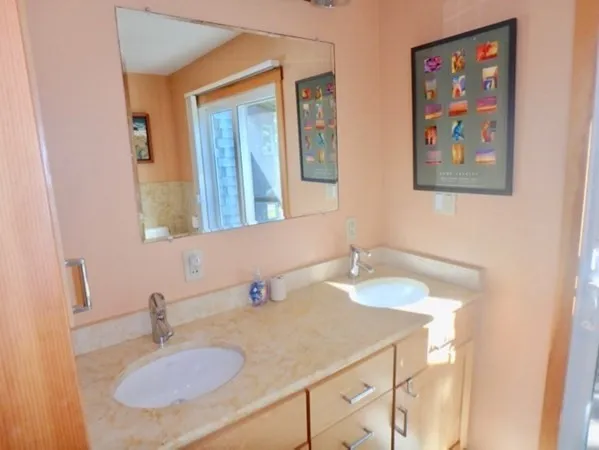 a bathroom with 2 sink and a mirror