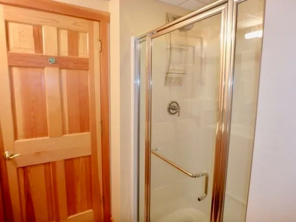 a bathroom with a glass shower door