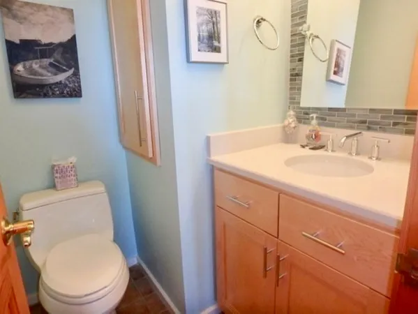 a bathroom with a toilet a sink and a mirror