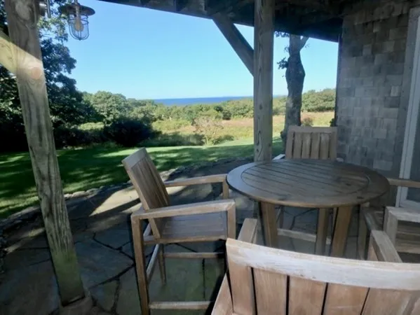 a view of balcony with wooden floor and outdoor seating