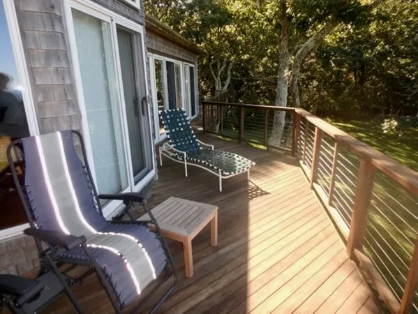 a view of balcony with two chairs and wooden floor