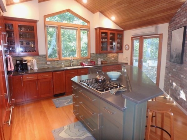 29 Cemetery Road Chilmark, MA 02535 - Photo 4 of 32 a kitchen with a stove a sink and a wooden cabinets