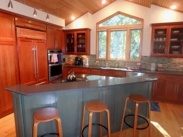 a dining table chair next to a window
