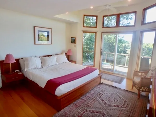 a bedroom with a large bed and a large window