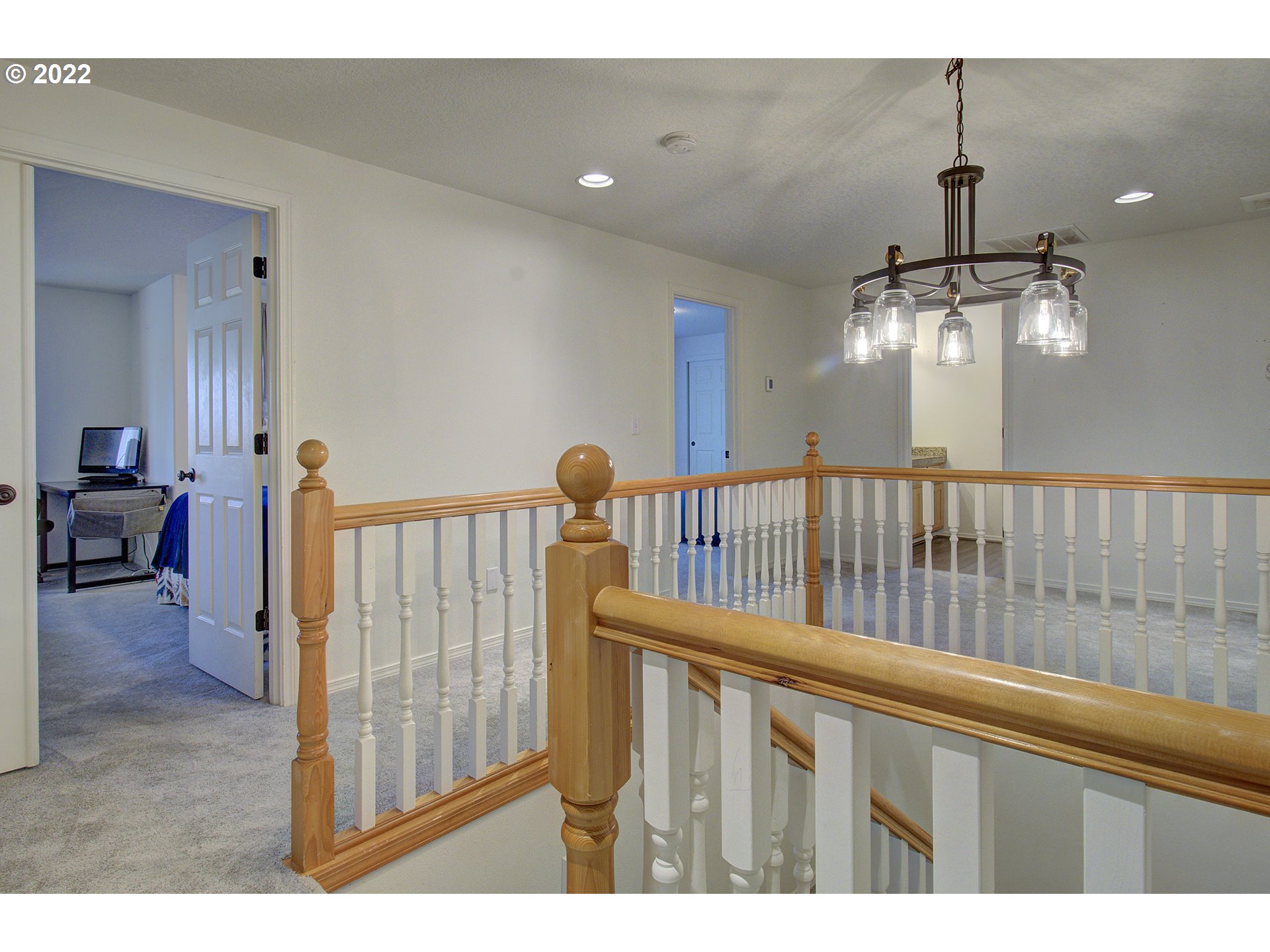 810 Raven Drive Ridgefield, WA 98642 - Photo 16 of 32 a view of staircase with railing and a chandelier