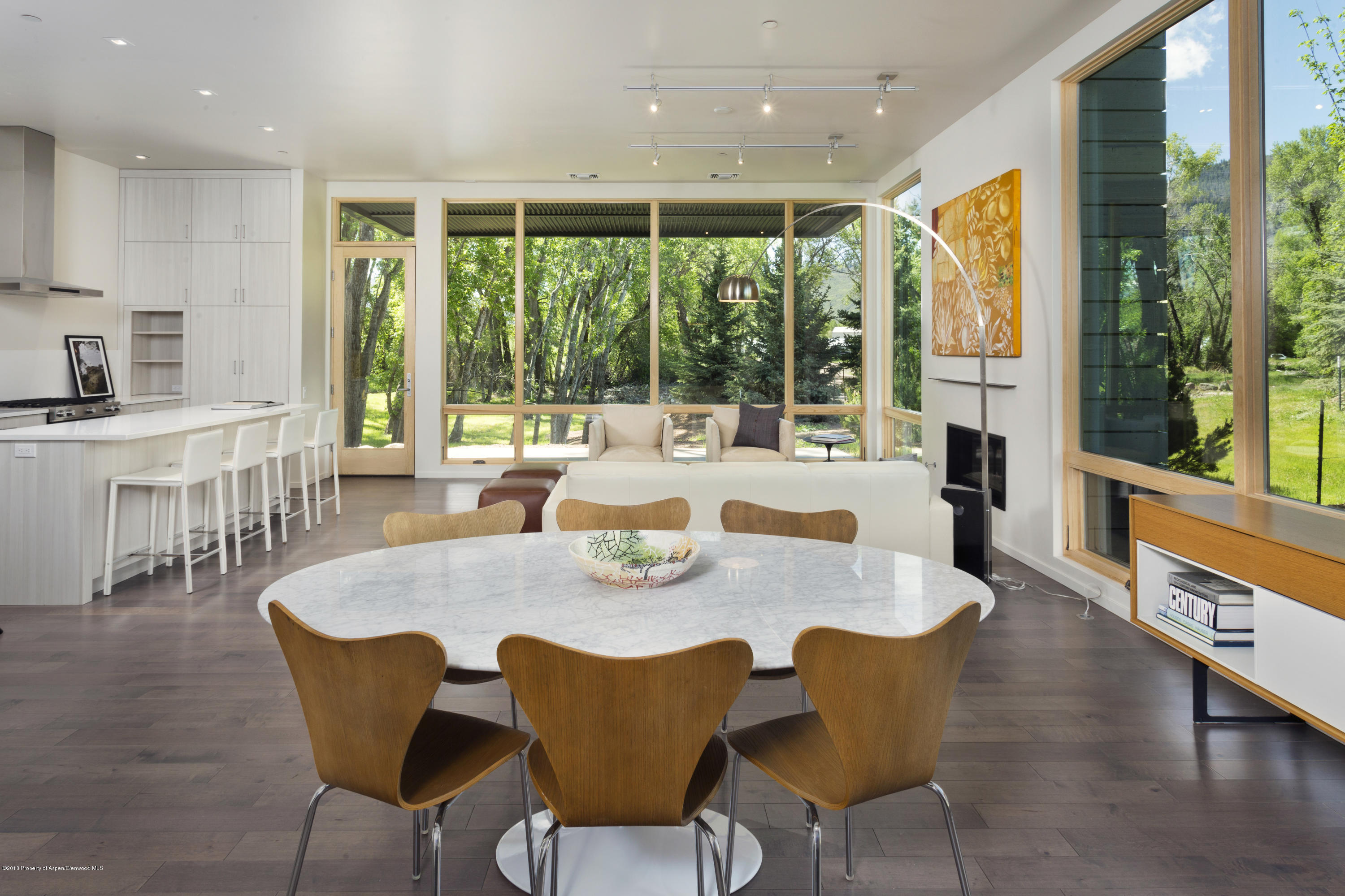 100 Evans Road, Unit 104 Basalt, CO 81621 - Photo 5 of 24 a view of a dining room with furniture large windows and wooden floor