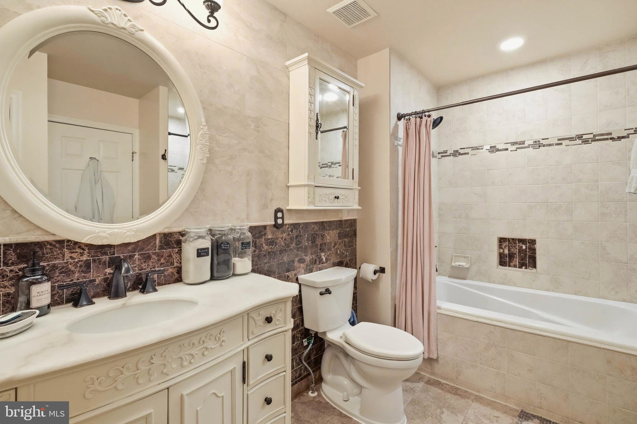 8721 Spring Brook Way Odenton, MD 21113 - Photo 25 of 40 a bathroom with a sink a toilet and shower