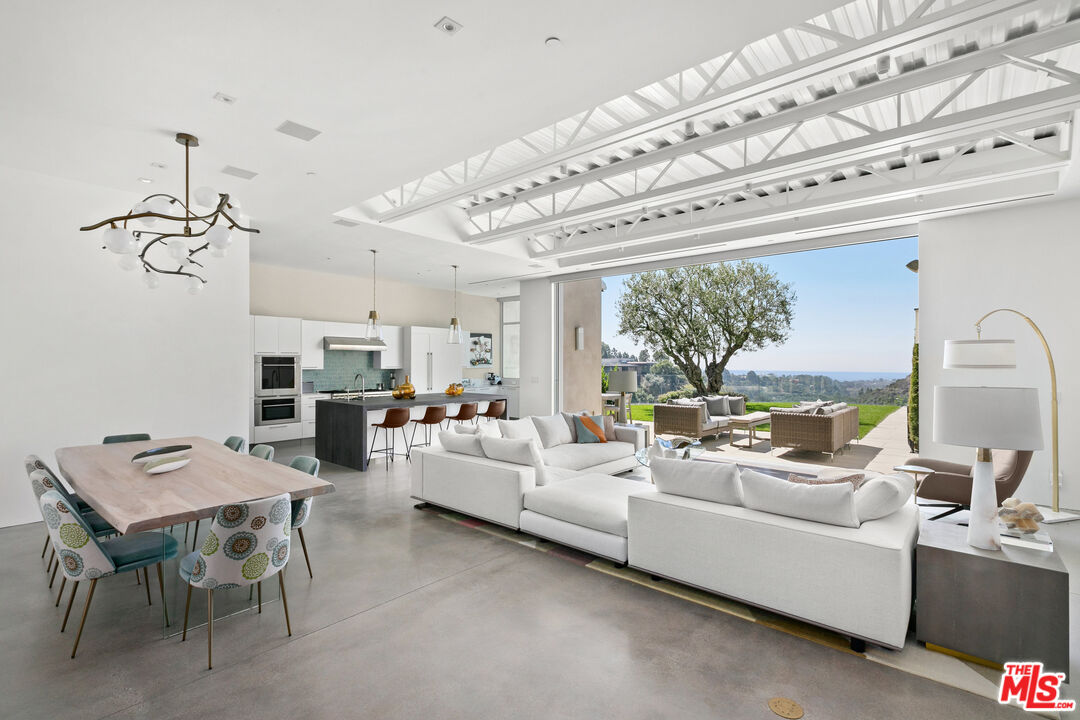 1550 Casale Road Pacific Palisades, CA 90272 - Photo 1 of 29 a living room with furniture and a large window