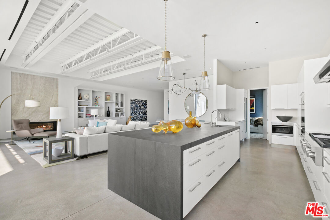 1550 Casale Road Pacific Palisades, CA 90272 - Photo 13 of 29 a kitchen that has a lot of cabinets and wooden floor