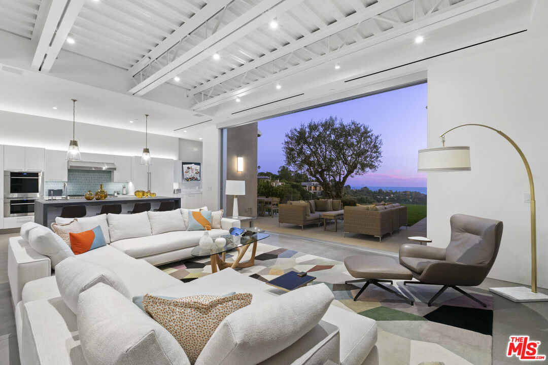 1550 Casale Road Pacific Palisades, CA 90272 - Photo 2 of 29 a living room with furniture and a flat screen tv