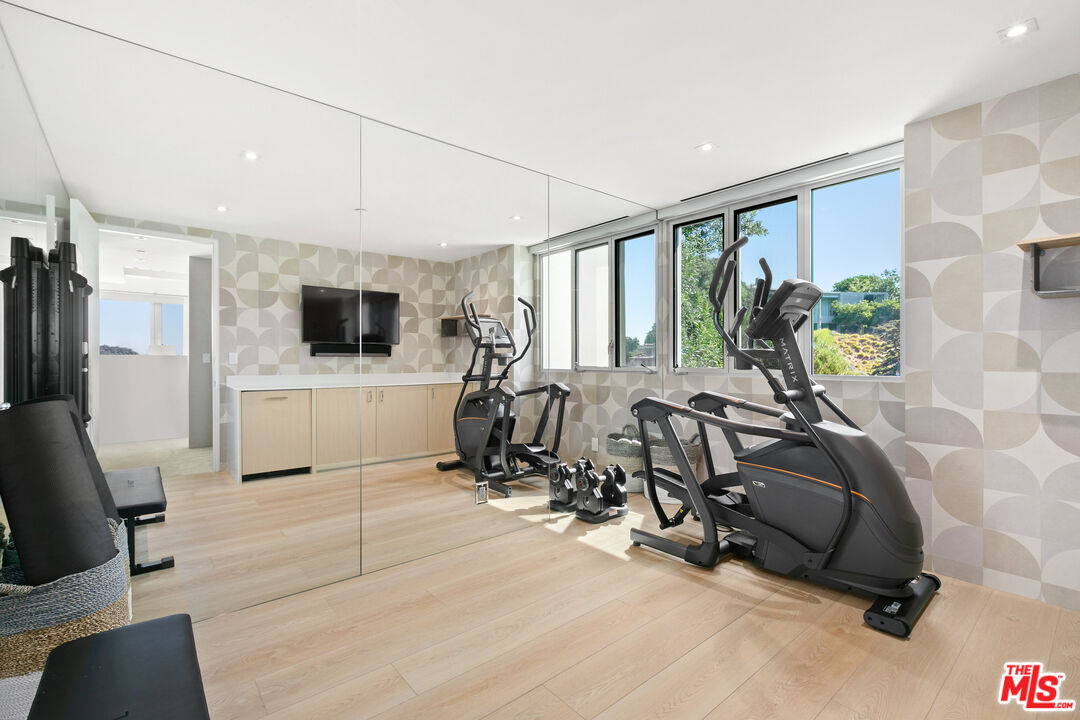1550 Casale Road Pacific Palisades, CA 90272 - Photo 21 of 29 a view of a livingroom with furniture and a flat screen tv
