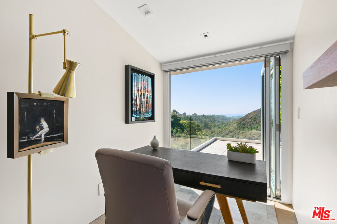 1550 Casale Road Pacific Palisades, CA 90272 - Photo 22 of 29 a living room with furniture and a window